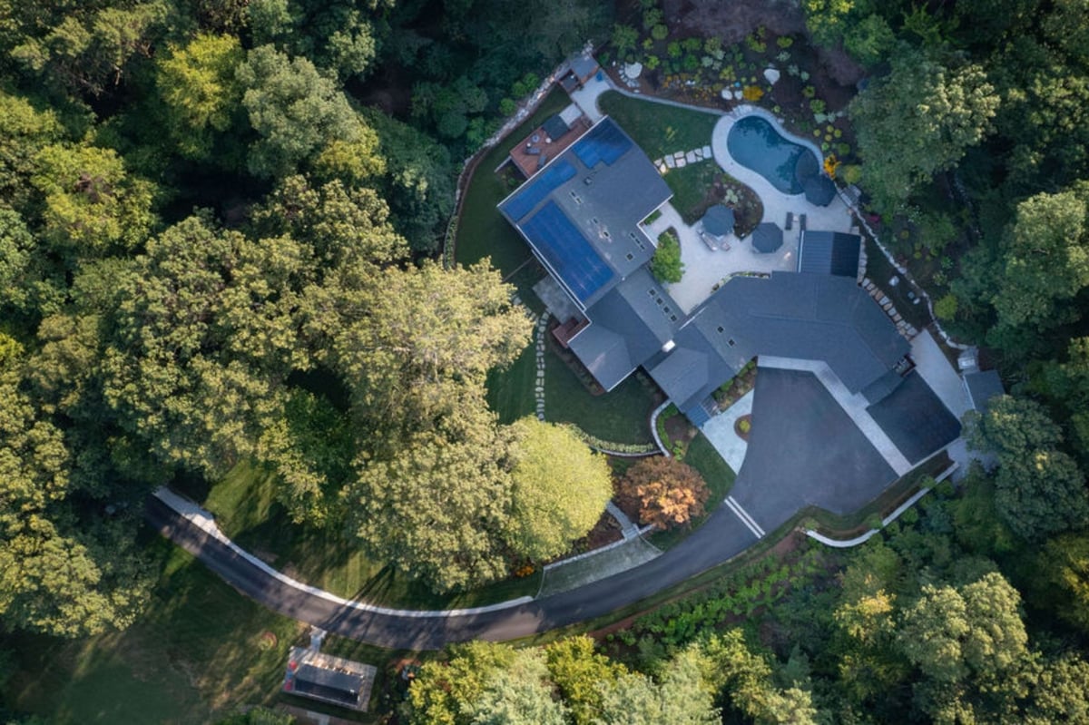 Aerial view of black and white modern farmhouse renovation in acton, massachusetts