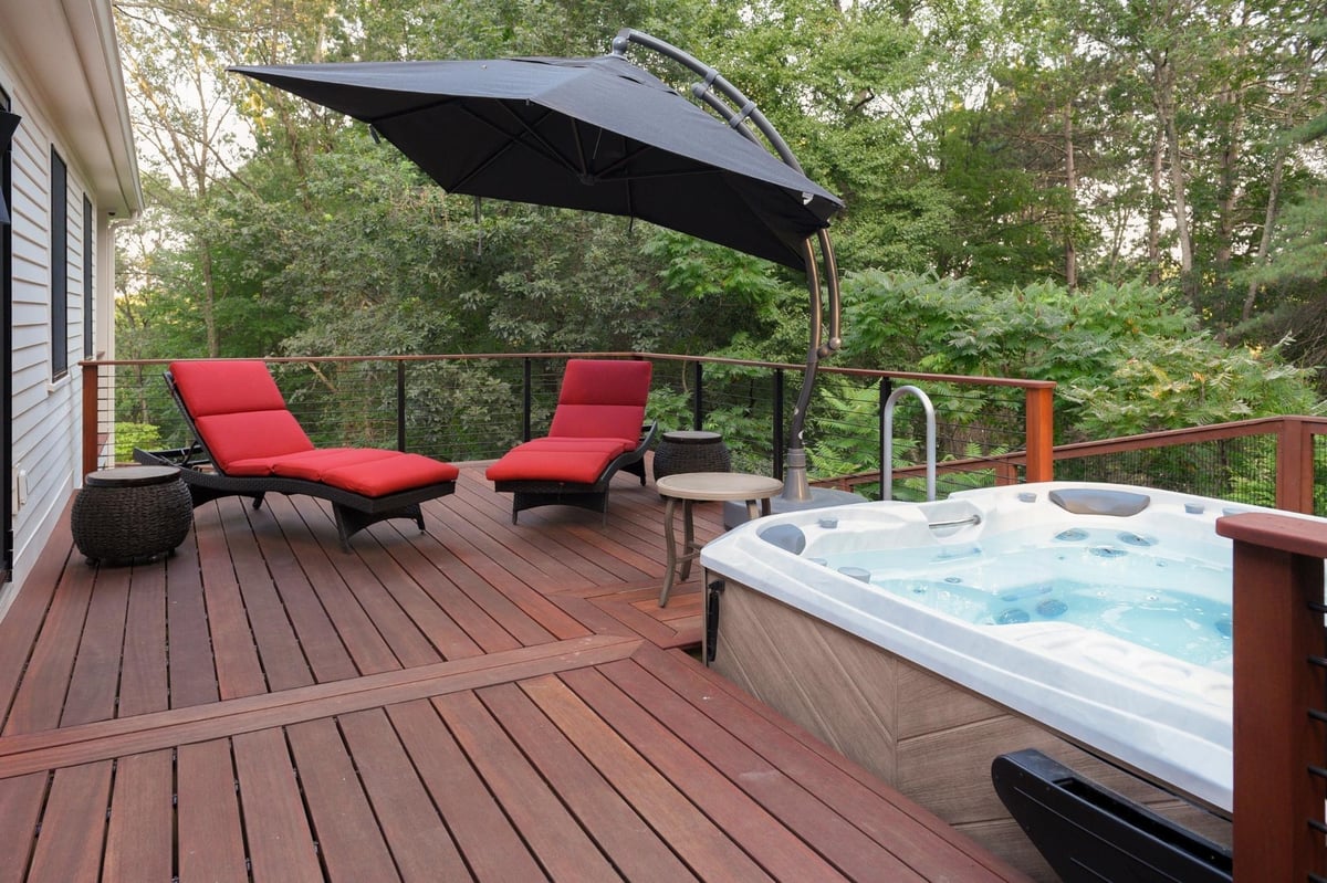 Black and white modern farmhouse renovation in acton, massachusetts with hot tub and deck