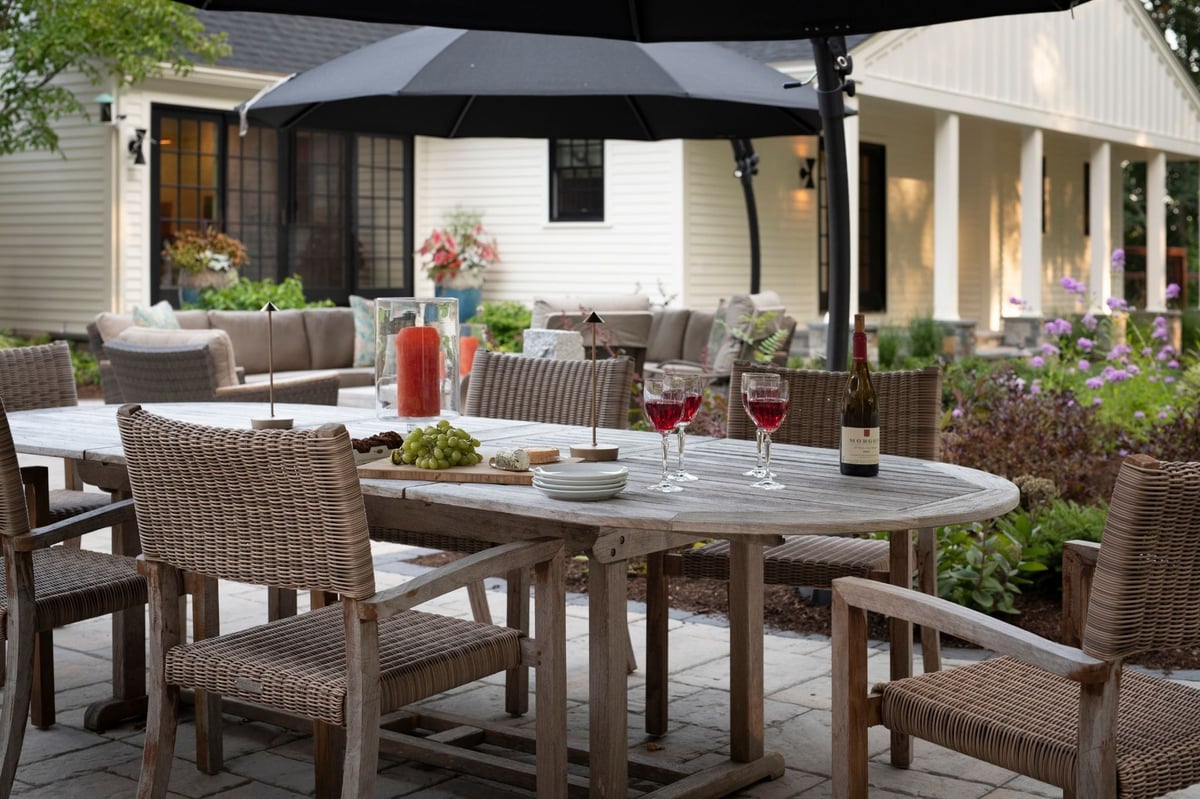 Black and white modern farmhouse renovation in acton, massachusetts with outdoor dining patio