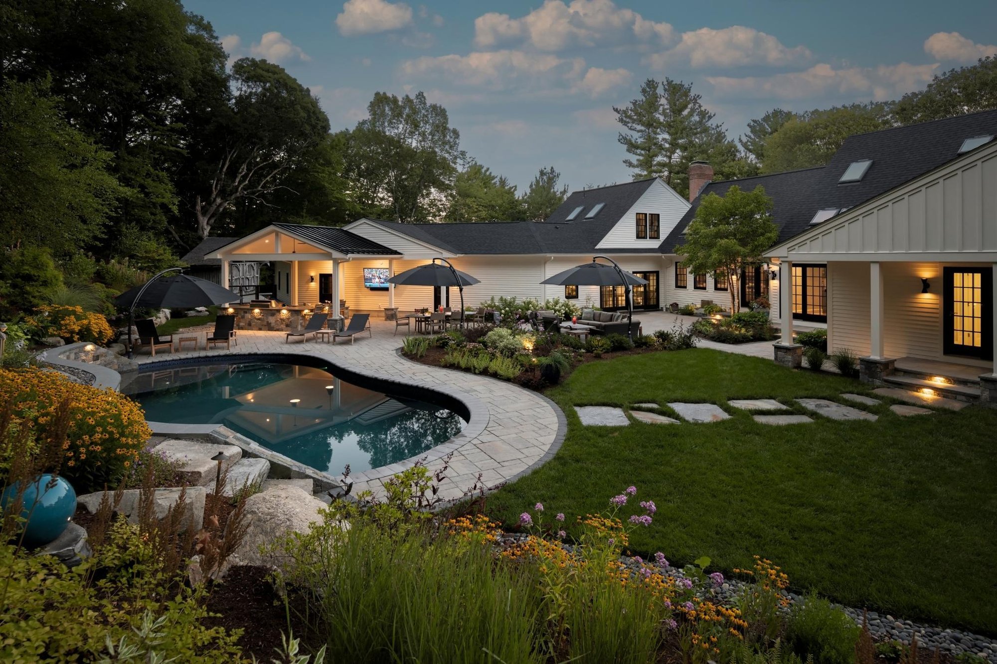 Black and white modern farmhouse renovation in acton, massachusetts with pool and outdoor entertainment