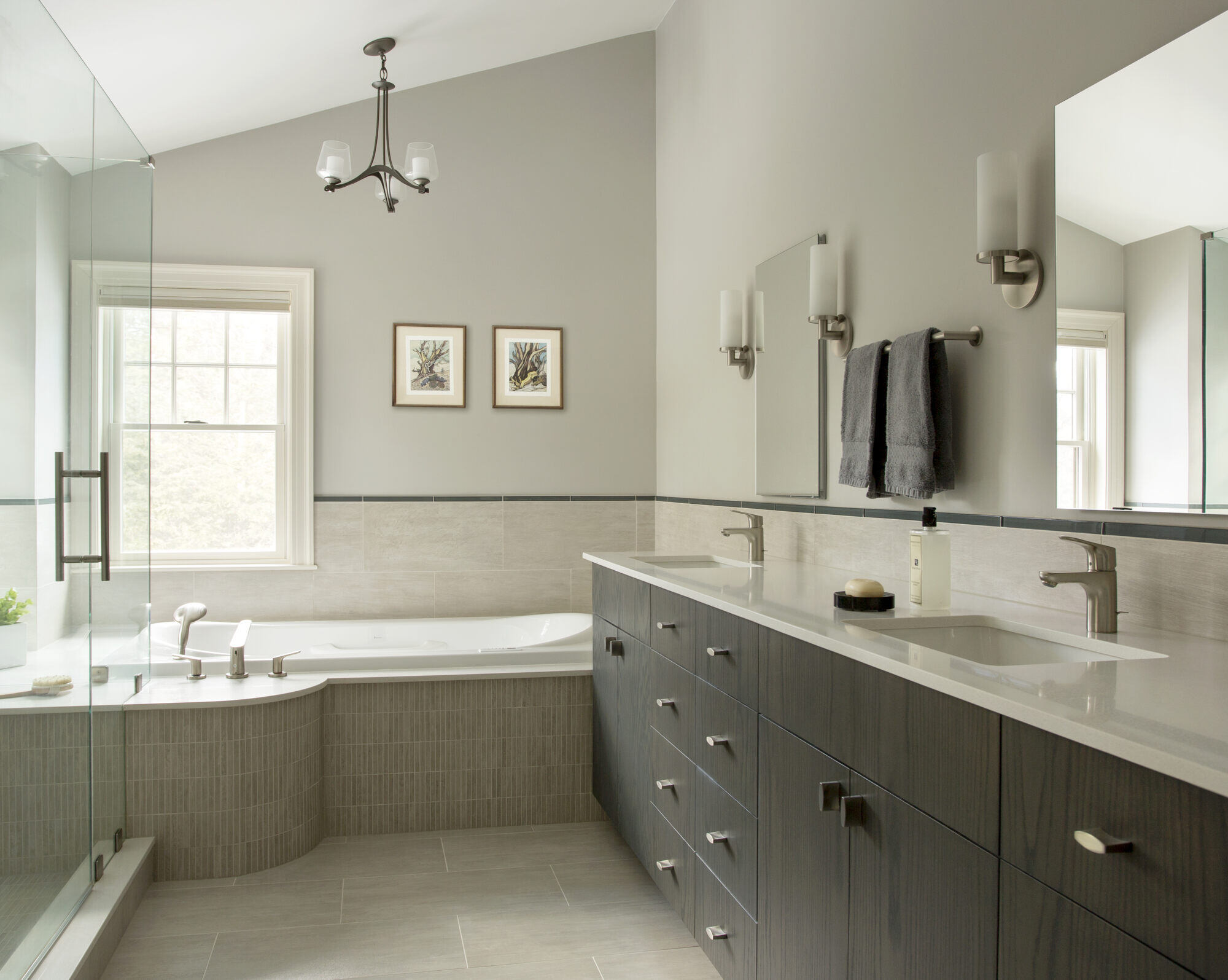 Elegant master bathroom renovation with a soaking tub and dual sinks, completed by Thomas Buckborough in a Boston home addition