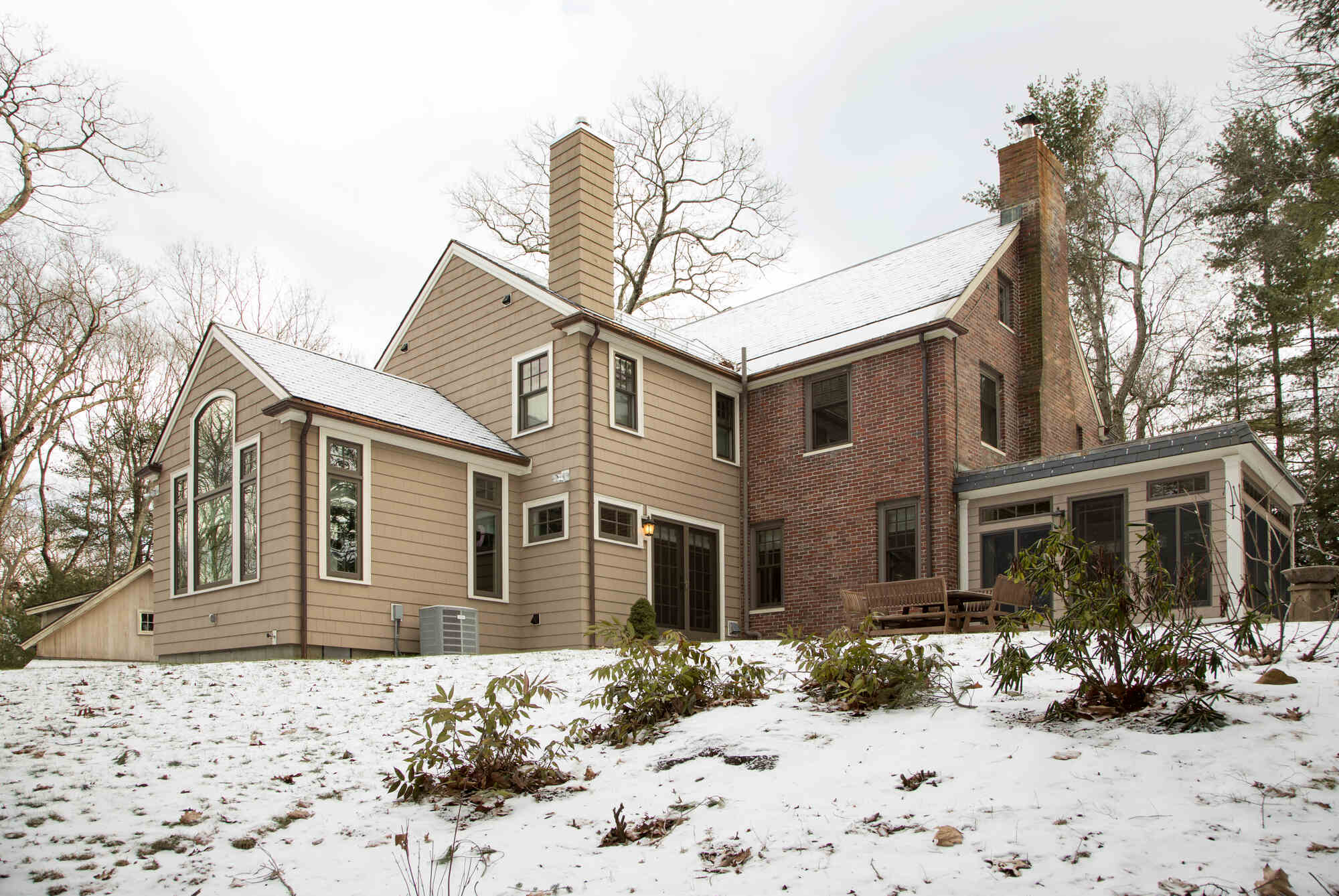 Renovated exterior of a Boston home, featuring classic architecture and a winter landscape, completed by Thomas Buckborough Renovated exterior of a Boston home, featuring classic architecture and a winter landscape, completed by Thomas Buckborough