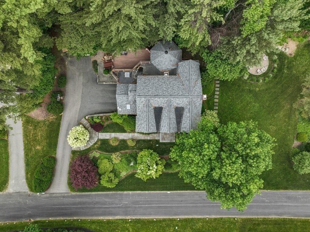 Aerial view of a beautifully renovated home and landscaped yard in Boston, MA, showcasing a home addition by Thomas Buckborough