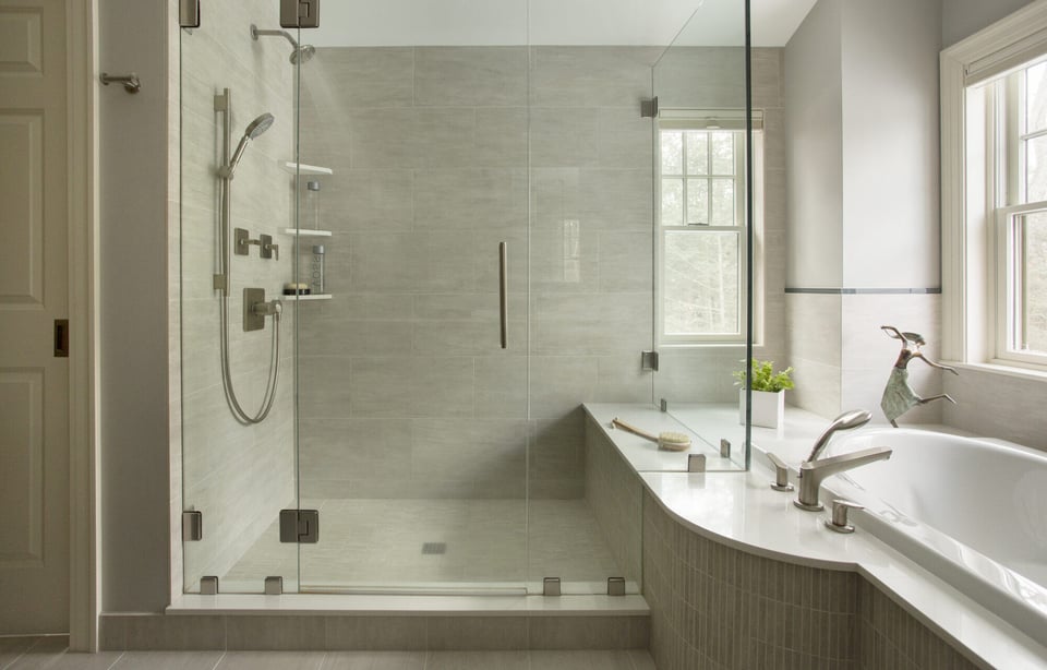 Modern master bath design in Acton, MA, by Thomas Buckborough, with a large glass shower and built-in shelving