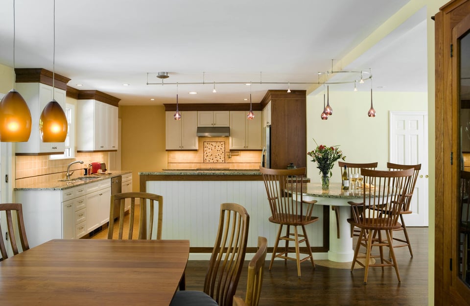 Elegant white kitchen renovation by Thomas Buckborough in Boston, MA, showcasing custom cabinetry, quartz countertops, and a large center island