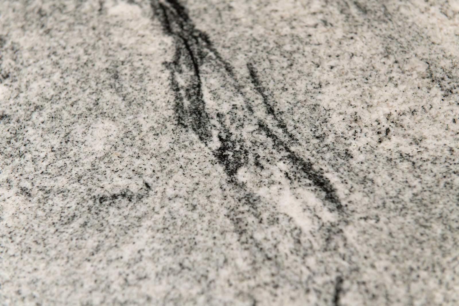 Elegant stone surface with intricate veining, featured in a custom kitchen remodel by Thomas Buckborough & Associates