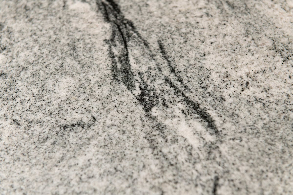Elegant stone surface with intricate veining, featured in a custom kitchen remodel by Thomas Buckborough & Associates