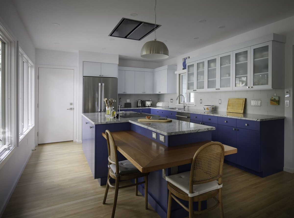 Modern kitchen remodel in Acton, MA, featuring blue lower cabinets and light upper cabinets by Thomas Buckborough & Associates