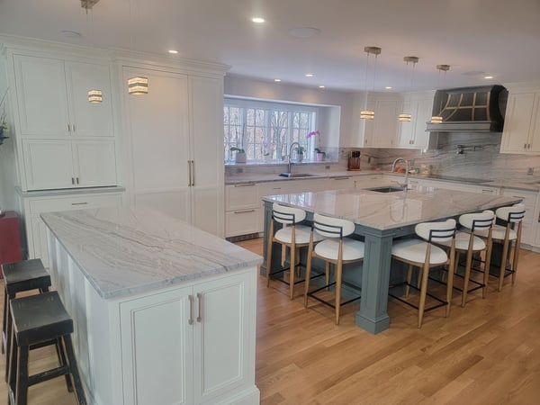 Bright and airy kitchen featuring a statement island and stylish lighting, part of a stunning remodel in Acton, MA