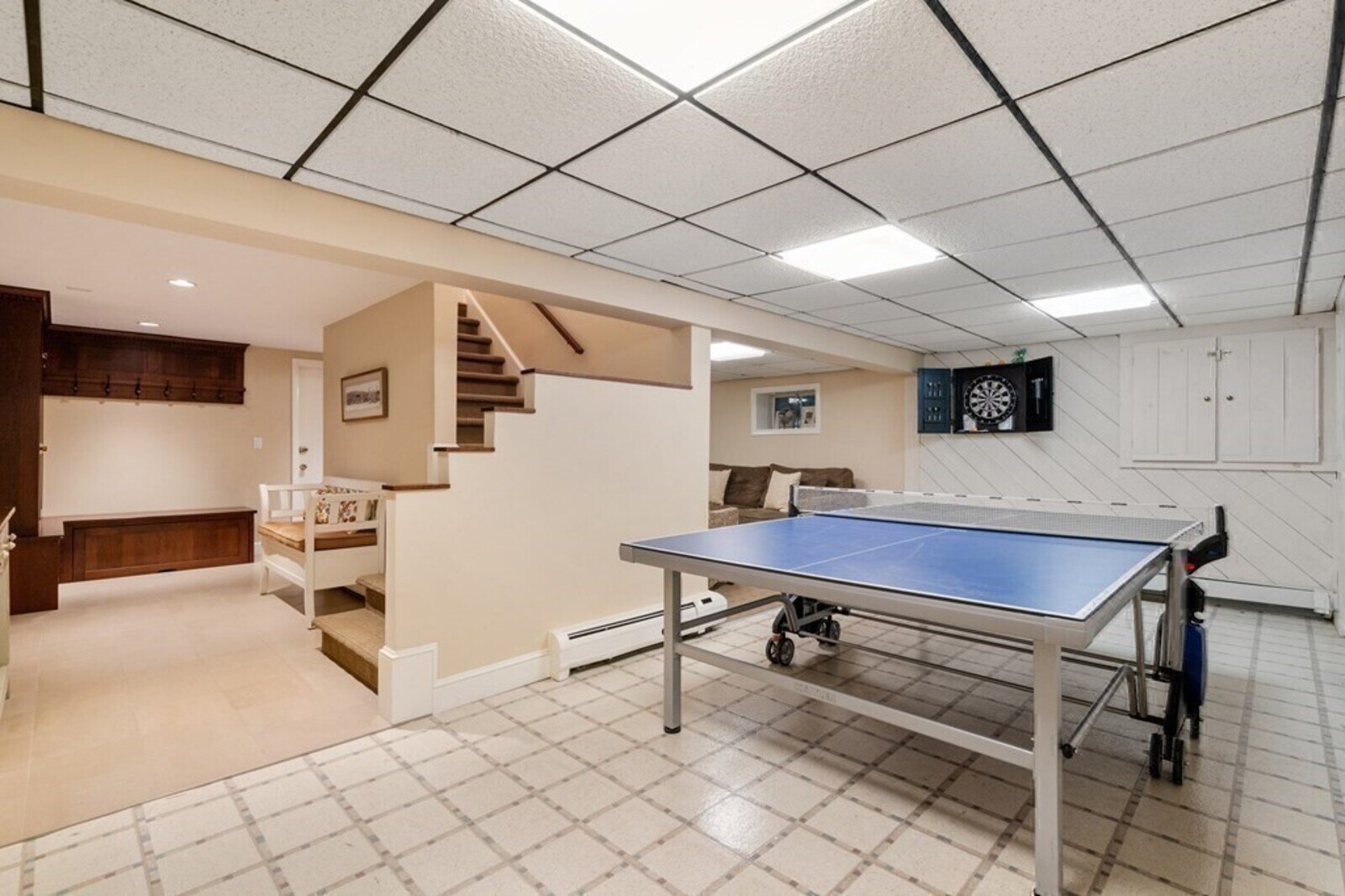 Acton MA home featuring remodeled basement with relaxation area by Thomas Buckborough & Associates