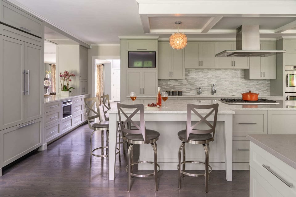 Kitchen remodel featuring a large island with seating, pendant lighting, and a high-end backsplash, designed by Thomas Buckborough &amp; Associates in Acton, MA