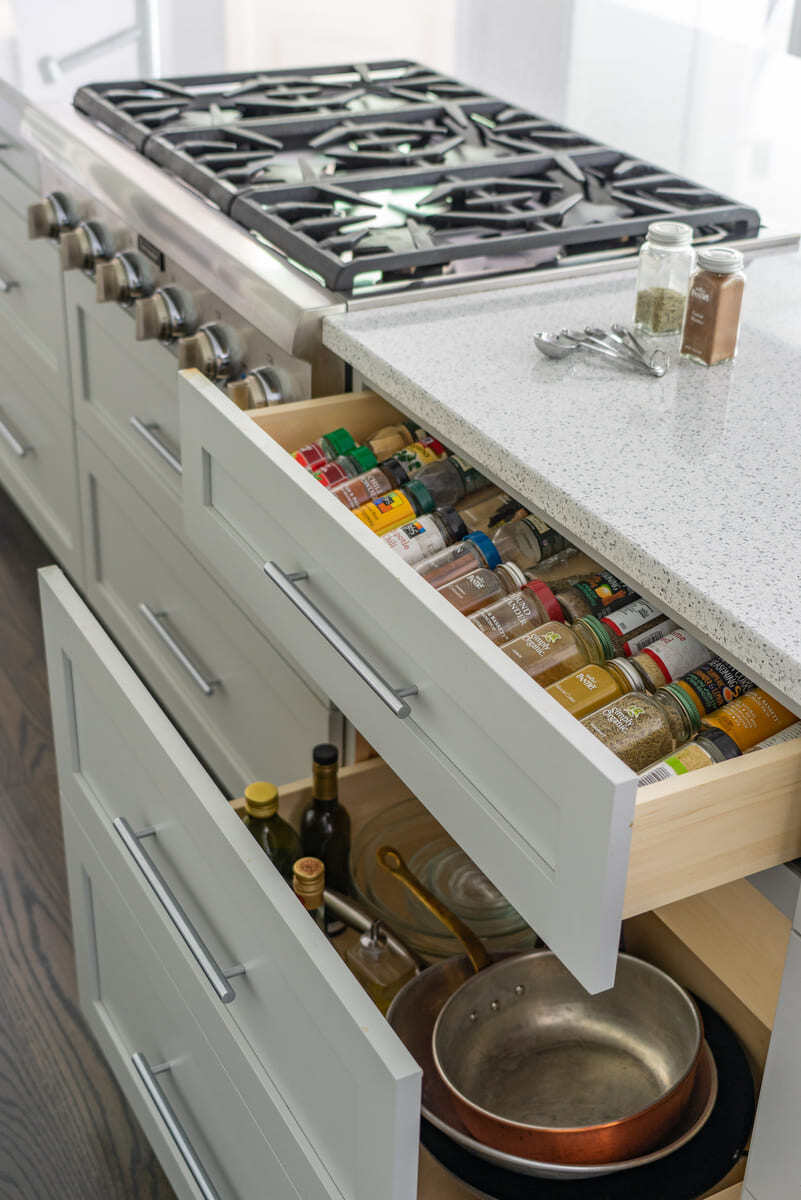 Organized spice and utensil drawers in a modern kitchen remodel by Thomas Buckborough & Associates in Acton, MA