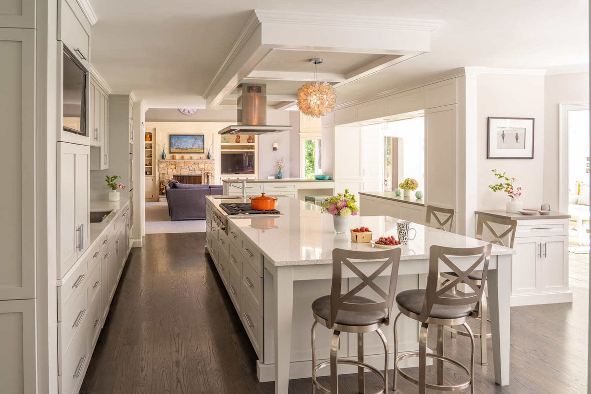 Spacious kitchen remodel with a large island, white cabinetry, and an open-concept design in Acton, MA, by Thomas Buckborough & Associates