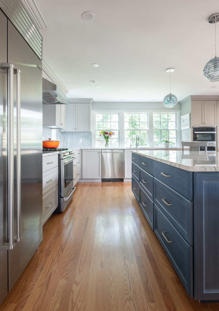 A kitchen transformation with custom cabinetry, a spacious cooking area, and a luxurious island designed by Thomas Buckborough & Associates