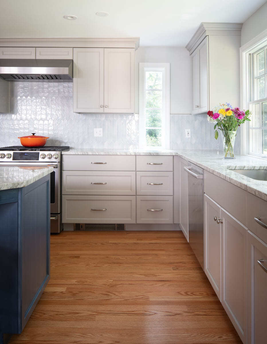 A luxurious kitchen renovation with an open-concept design, high-end appliances, and elegant pendant lighting by Thomas Buckborough & Associates