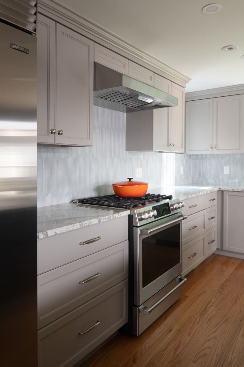 A remodeled kitchen in Acton, MA, featuring a modern double oven, custom cabinetry, and bright natural lighting