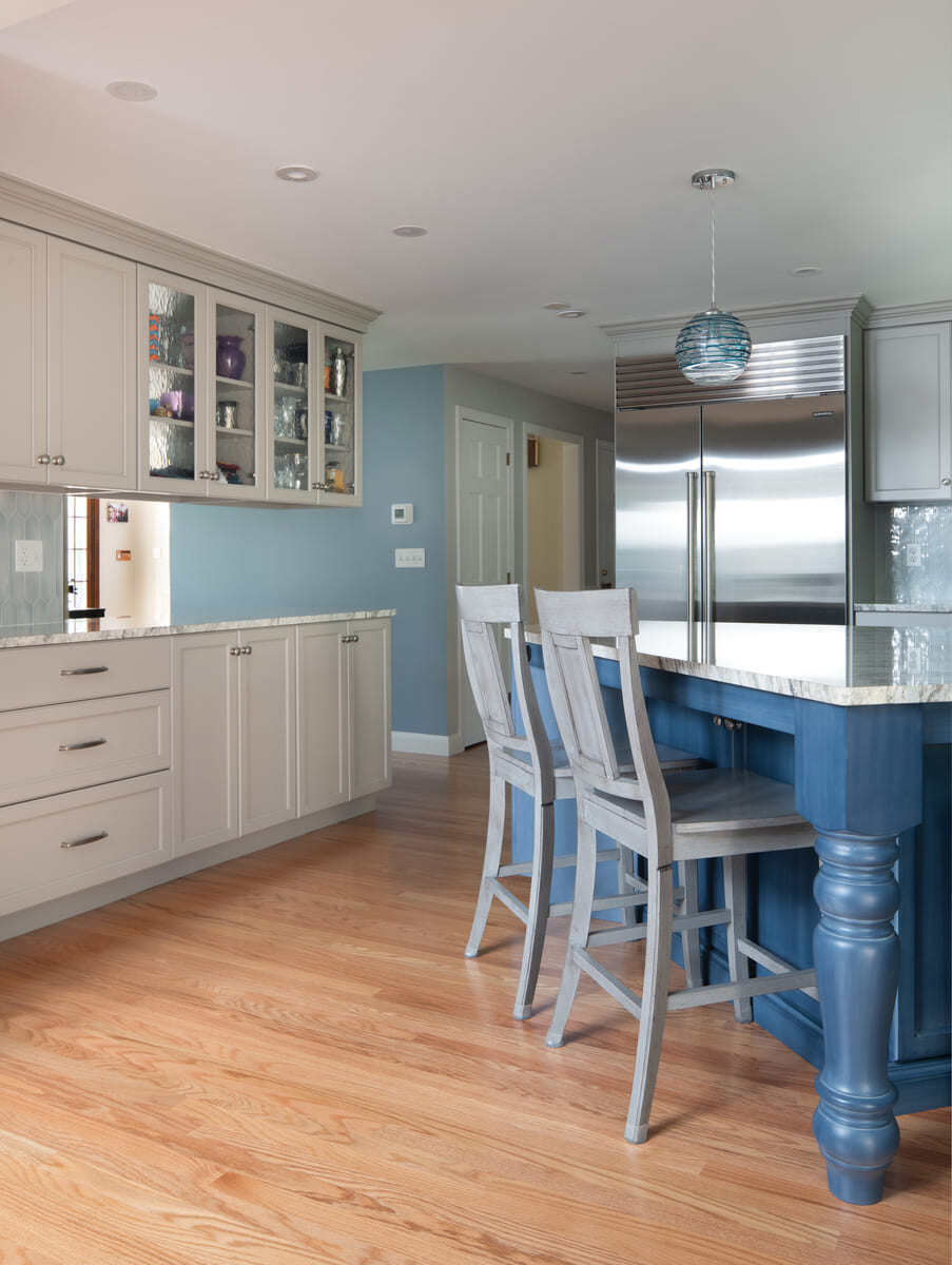 A renovated kitchen by Thomas Buckborough & Associates with gray cabinets, a blue island, and a bright open-concept layout