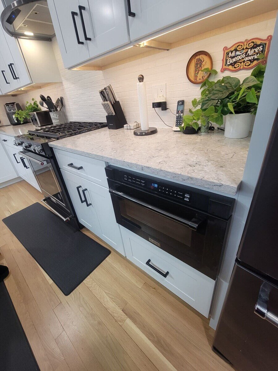 Custom kitchen remodel with efficient appliance placement, including a built-in microwave, for a seamless look in Acton, MA