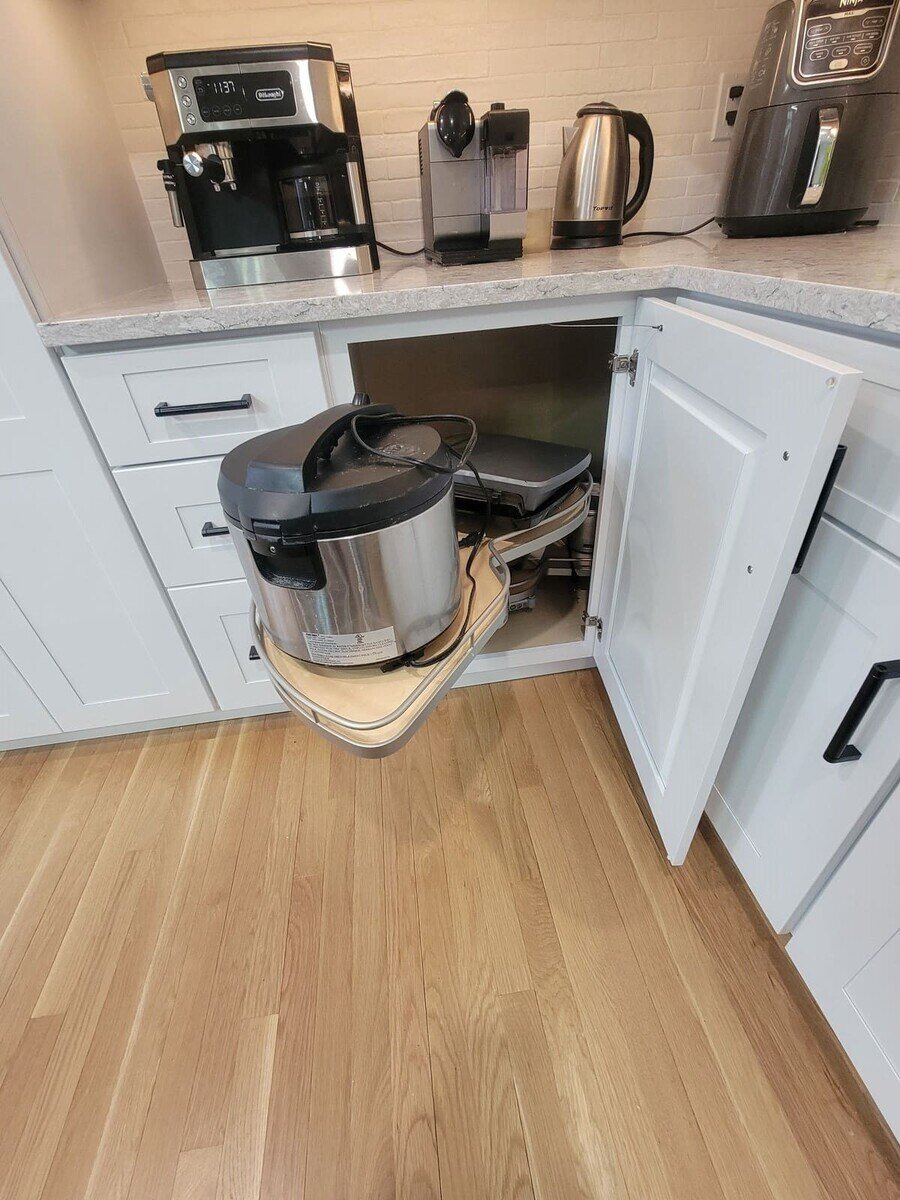 Smart storage solution for kitchen appliances featuring a pull-out cabinet shelf in a custom kitchen remodel
