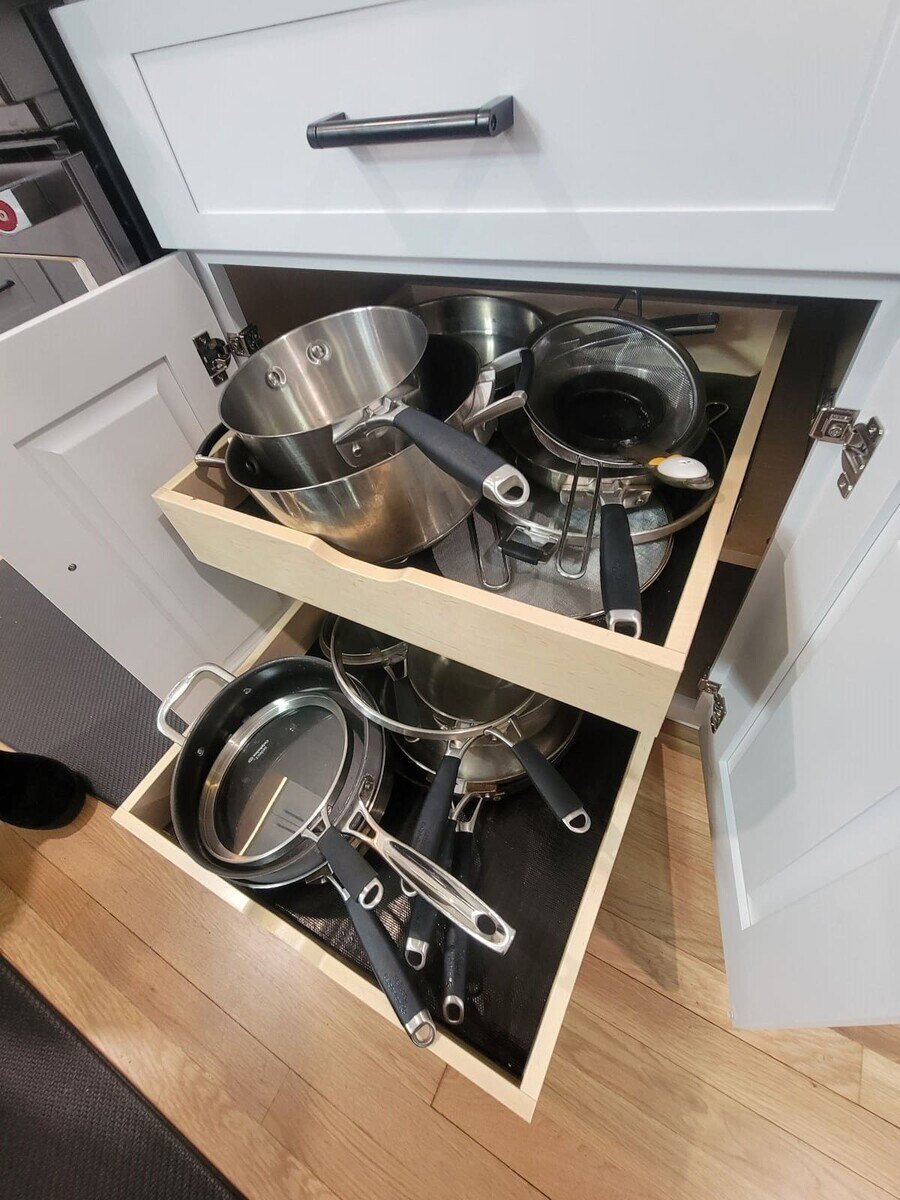 Space-efficient kitchen storage solution with a pull-out cabinet for easy access to pots and pans in Acton, MA