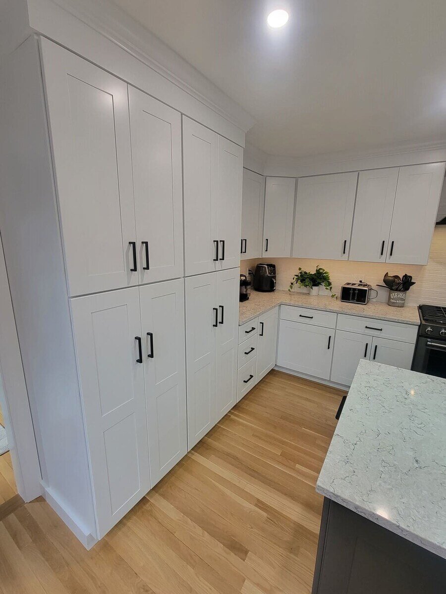 Spacious pantry cabinetry with shaker-style doors and modern hardware in a high-end kitchen renovation