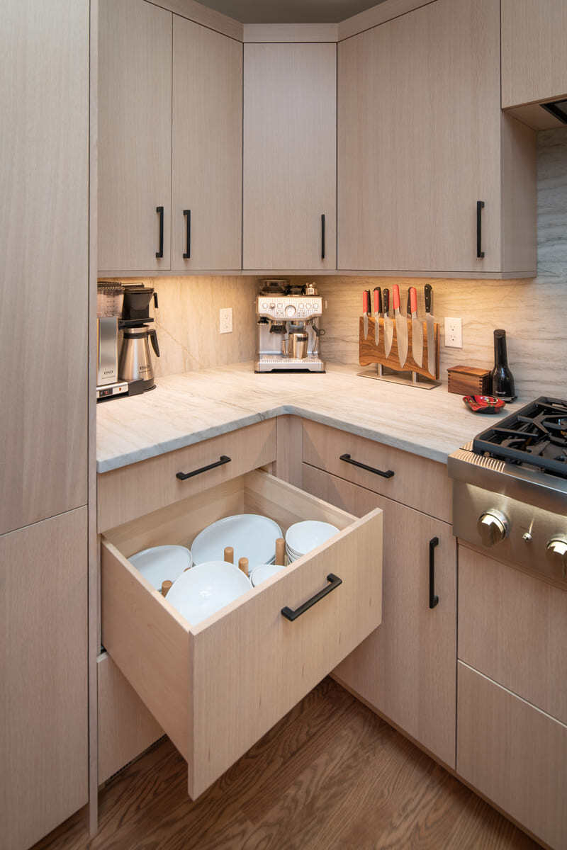 Custom kitchen drawer organization for plates and bowls in a Shea home remodel by Thomas Buckborough & Associates in Acton, MA