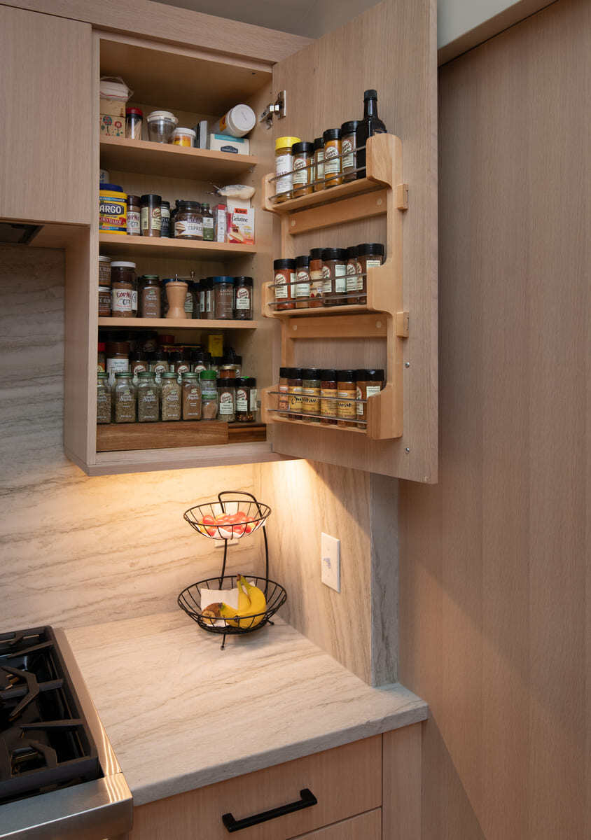 Smart kitchen storage solution with a neatly arranged spice cabinet and pull-out shelves in Acton, MA
