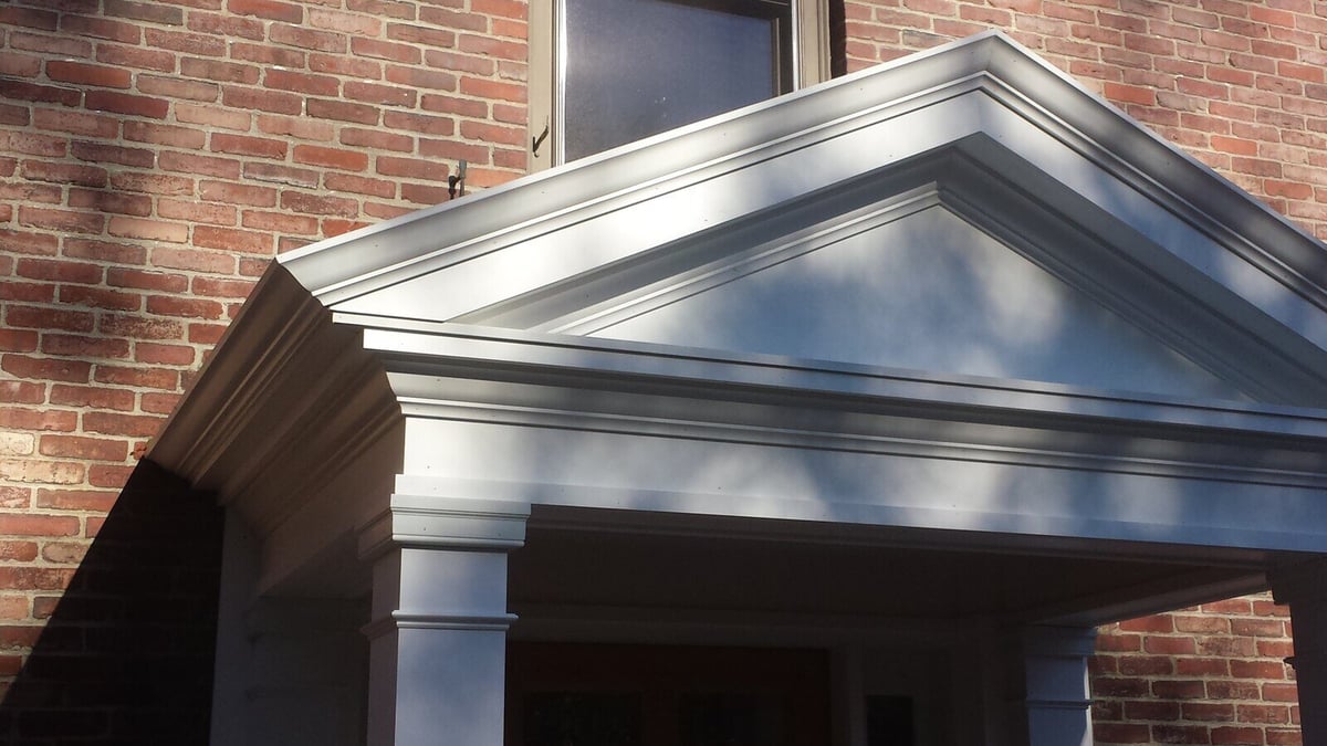 Close-up of detailed white portico trim during an exterior remodel by Thomas Buchborough in Greater Boston