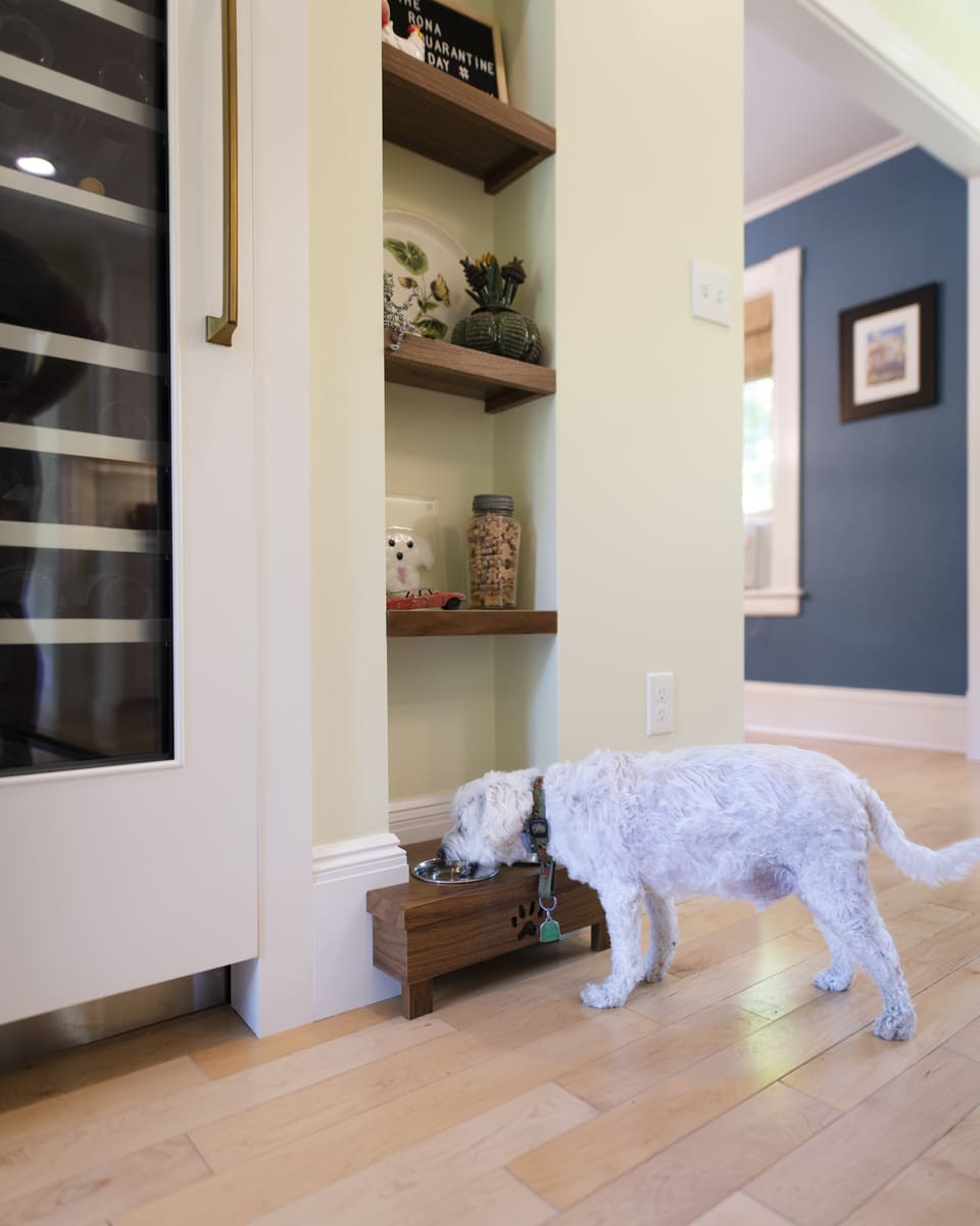 Custom kitchen design featuring a pet-friendly feeding station built into a cabinetry nook in an Acton, MA remodel