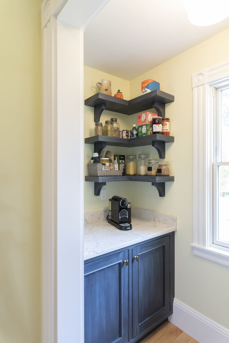 Elegant kitchen renovation with a professional gas range, brass pot filler, and shaker cabinets by Thomas Buckborough & Associates