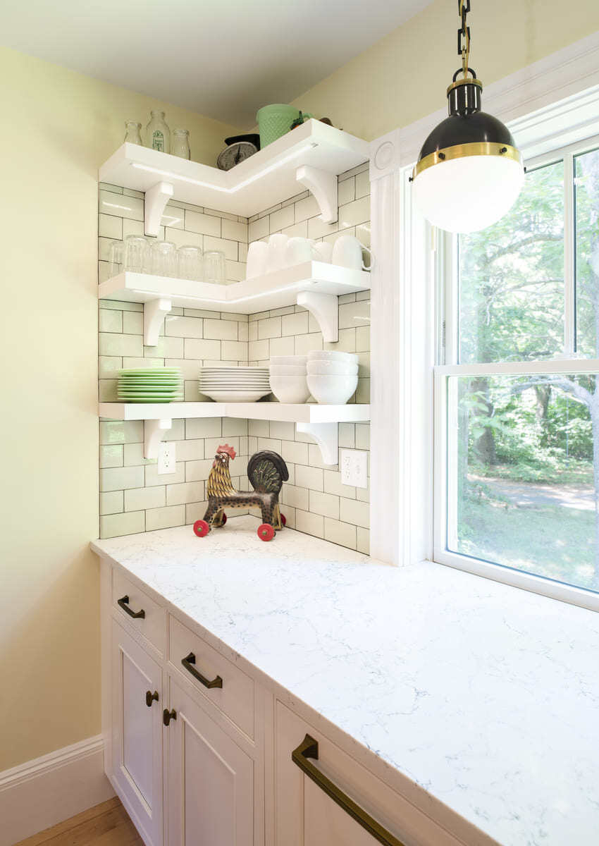 Home coffee bar with dark wood shelving, neatly organized glass jars, and a marble countertop in a kitchen remodel in Acton, MA