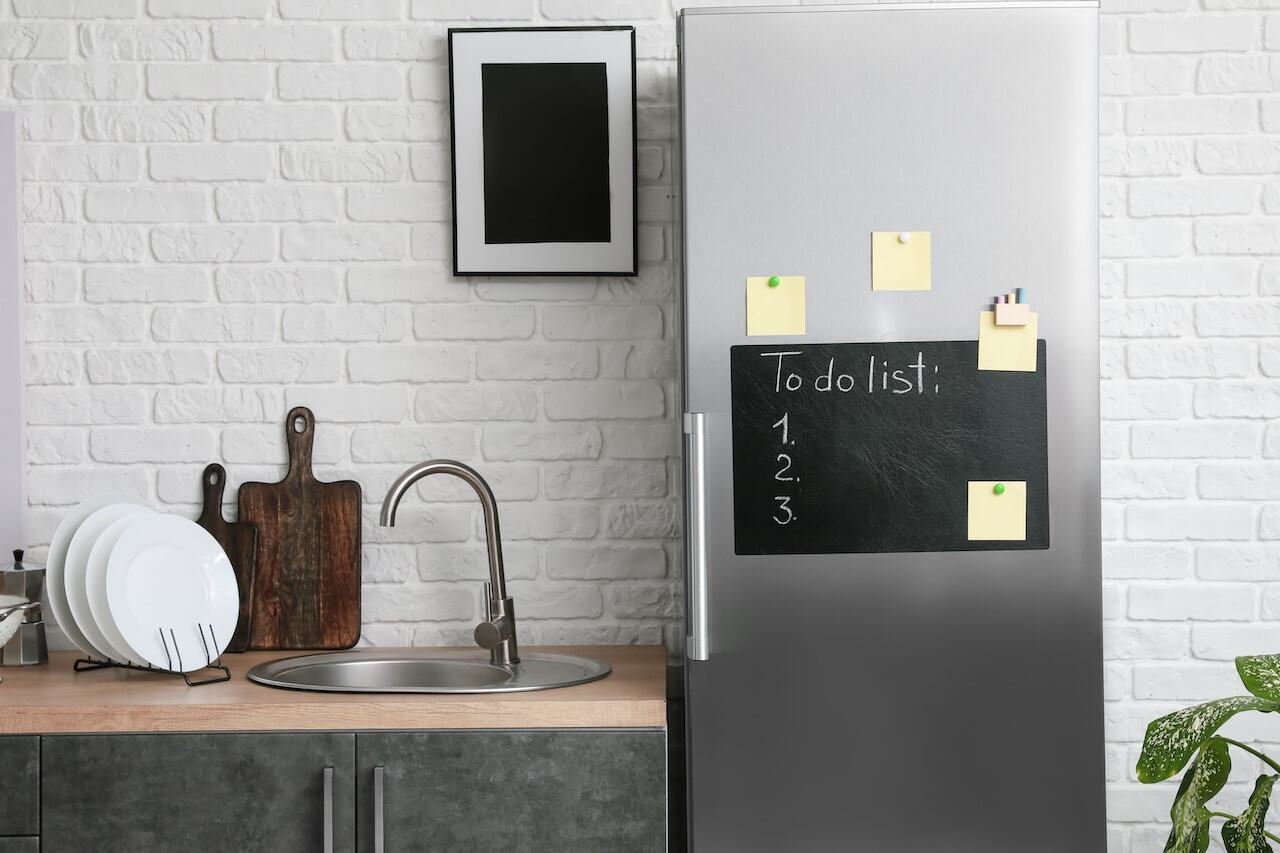 message board on door of refrigerator in kitchen