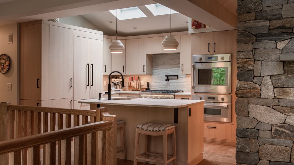 Kitchen remodel in greater boston with natural wood, flat panel cabinets and black handles