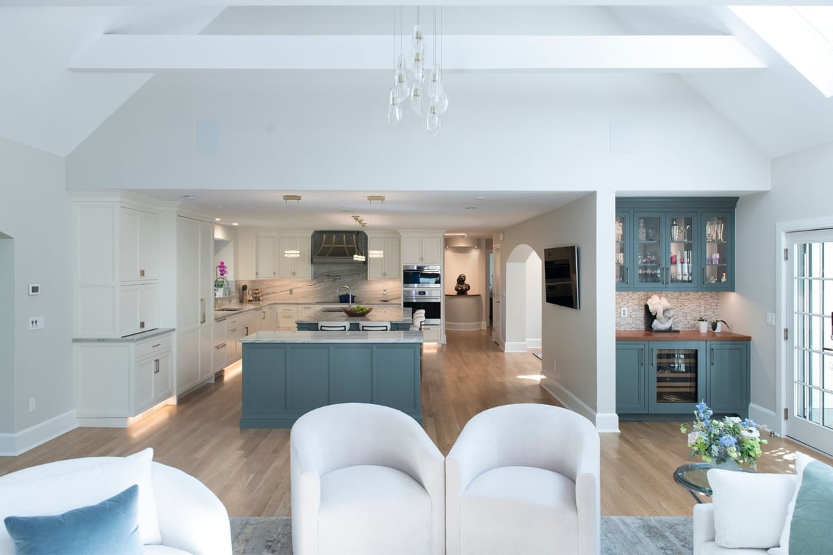 open concept kitchen with double islands and custom vent hoodin acton, ma