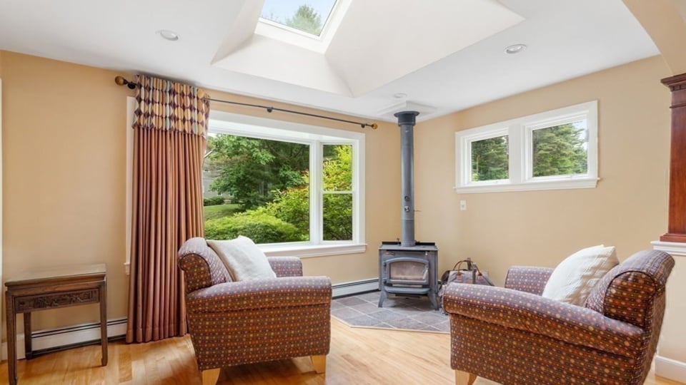 whole home remodel in greater boston with skylight, fireplace, and seating area in front of window