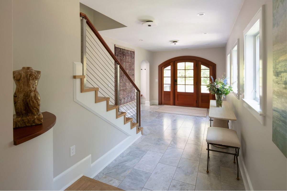whole home remodel in acton , ma with wood staircase and railing and large wood front door