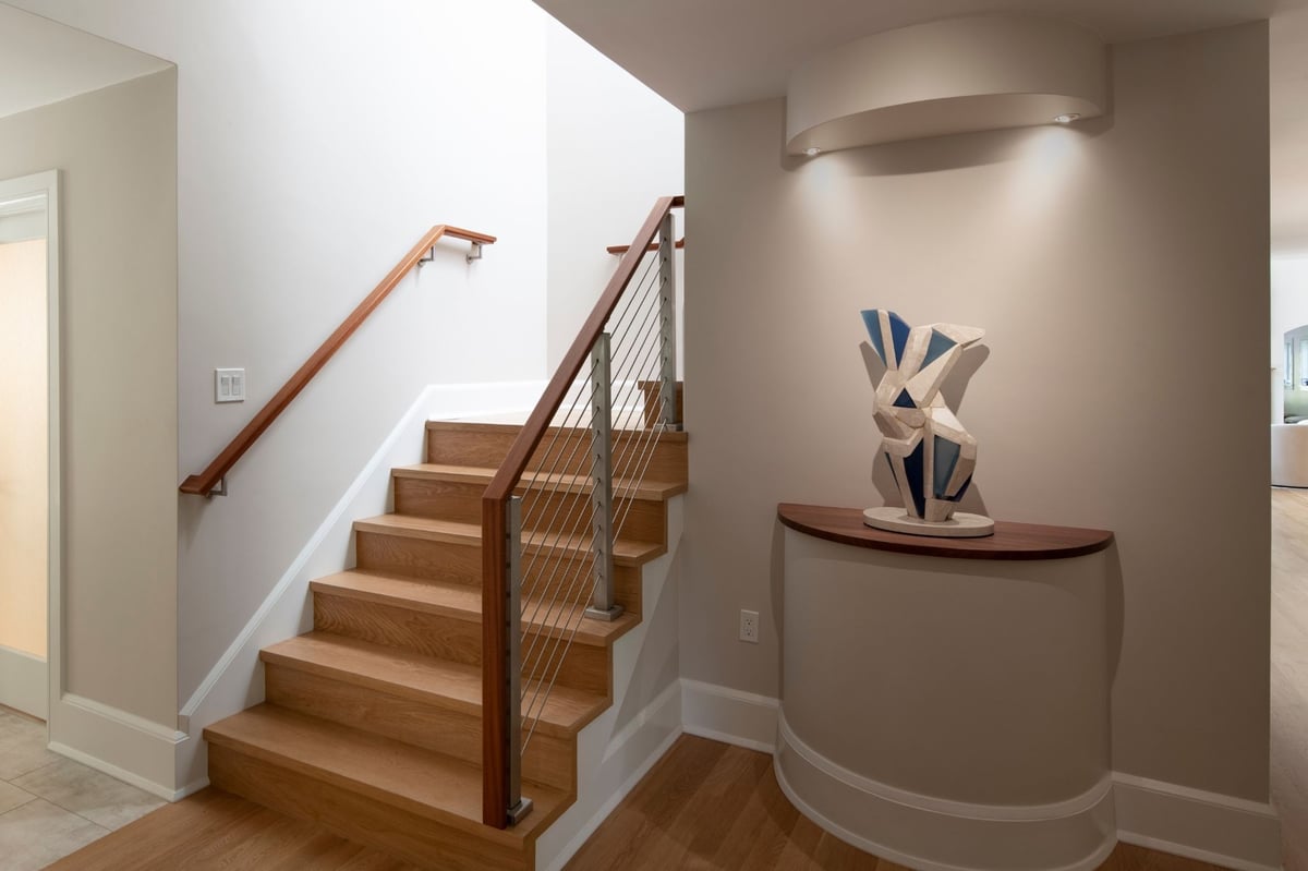 whole home remodel in acton , ma with wood staircase and railing and statue spotlights