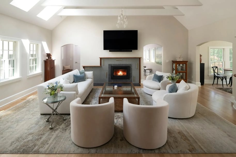 whole home renovation in acton with vaulted ceilings and fireplace in a bright, white living room