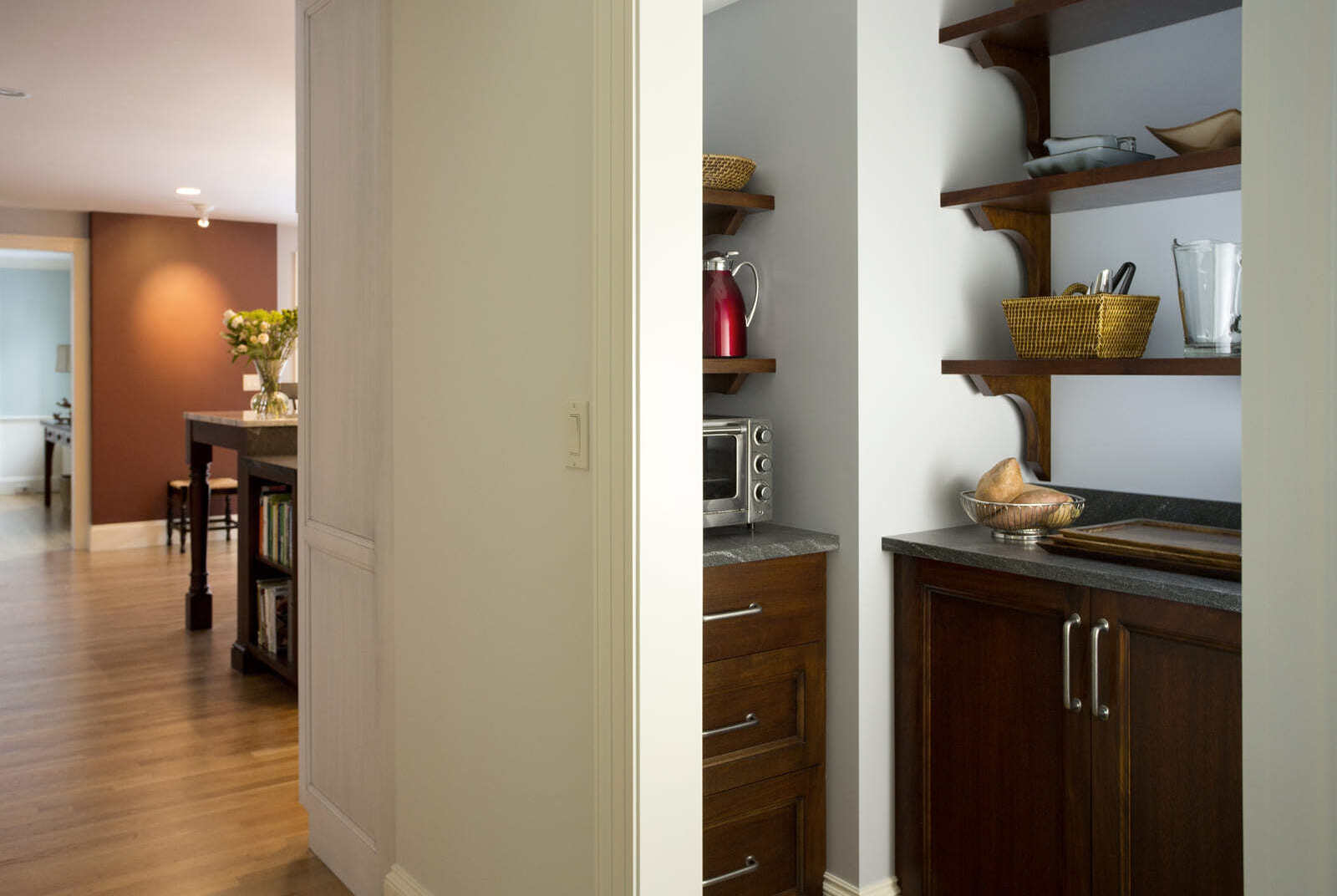 Custom-built pantry with dark wood cabinets and open shelving in a home renovation by Thomas Buckborough & Associates in Acton, MA (1)