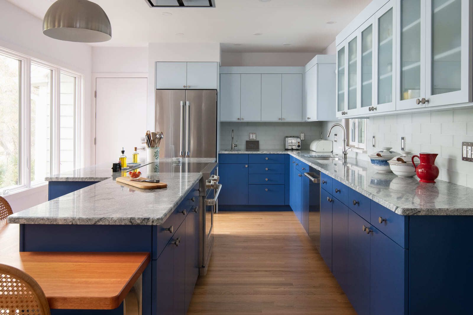 Elegant kitchen renovation in Acton, MA, with blue cabinetry, marble countertops, and modern lighting by Thomas Buckborough & Associates Elegant kitchen renovation in Acton, MA, with blue cabinetry, marble countertops, and modern lighting by Thomas Buckborough & Associates