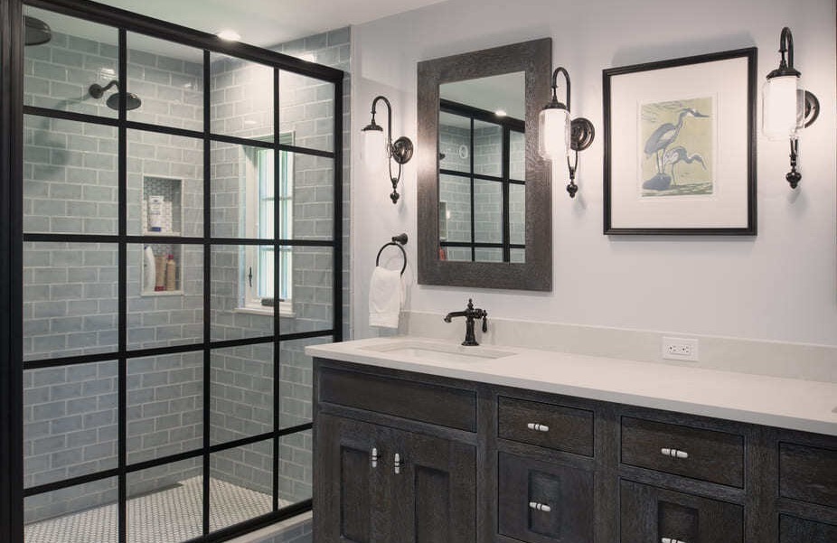 Sophisticated master bathroom with a spacious black-framed glass shower, soft gray subway tiles, and dark wood cabinetry in an Acton, MA renovation-1