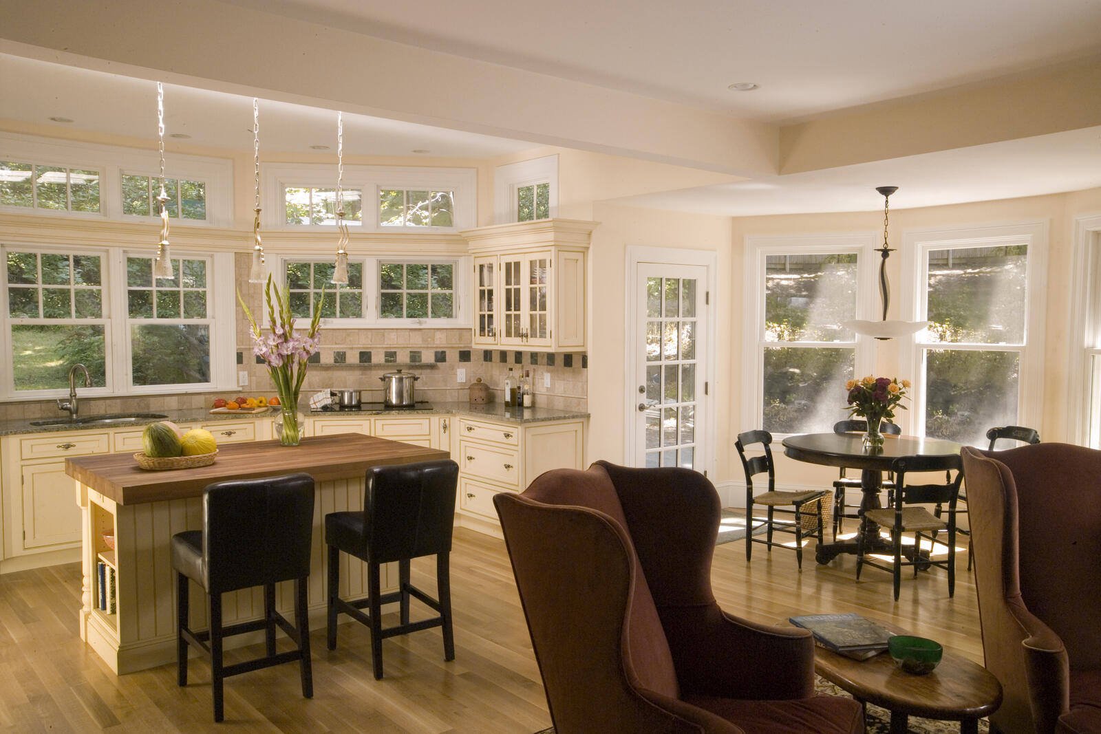 Bright and inviting custom kitchen remodel by Thomas Buckborough & Associates in Harvard, MA, featuring white cabinetry and natural wood accents